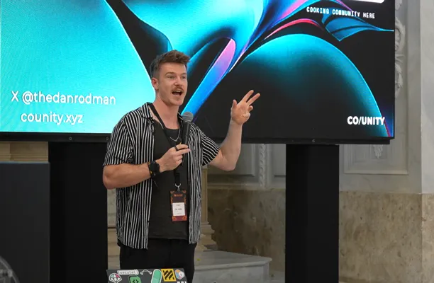 Dan speaking in front of the Co/Unity screen